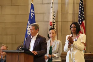 Nebraska Gov. Jim Pillen, JoAnna LeFlore-Ejike, and Ilyasah Shabazz speak at Malcolm X's Nebraska Hall of Fame induction ceremony. (Photo: Maya Marchel Hoff)